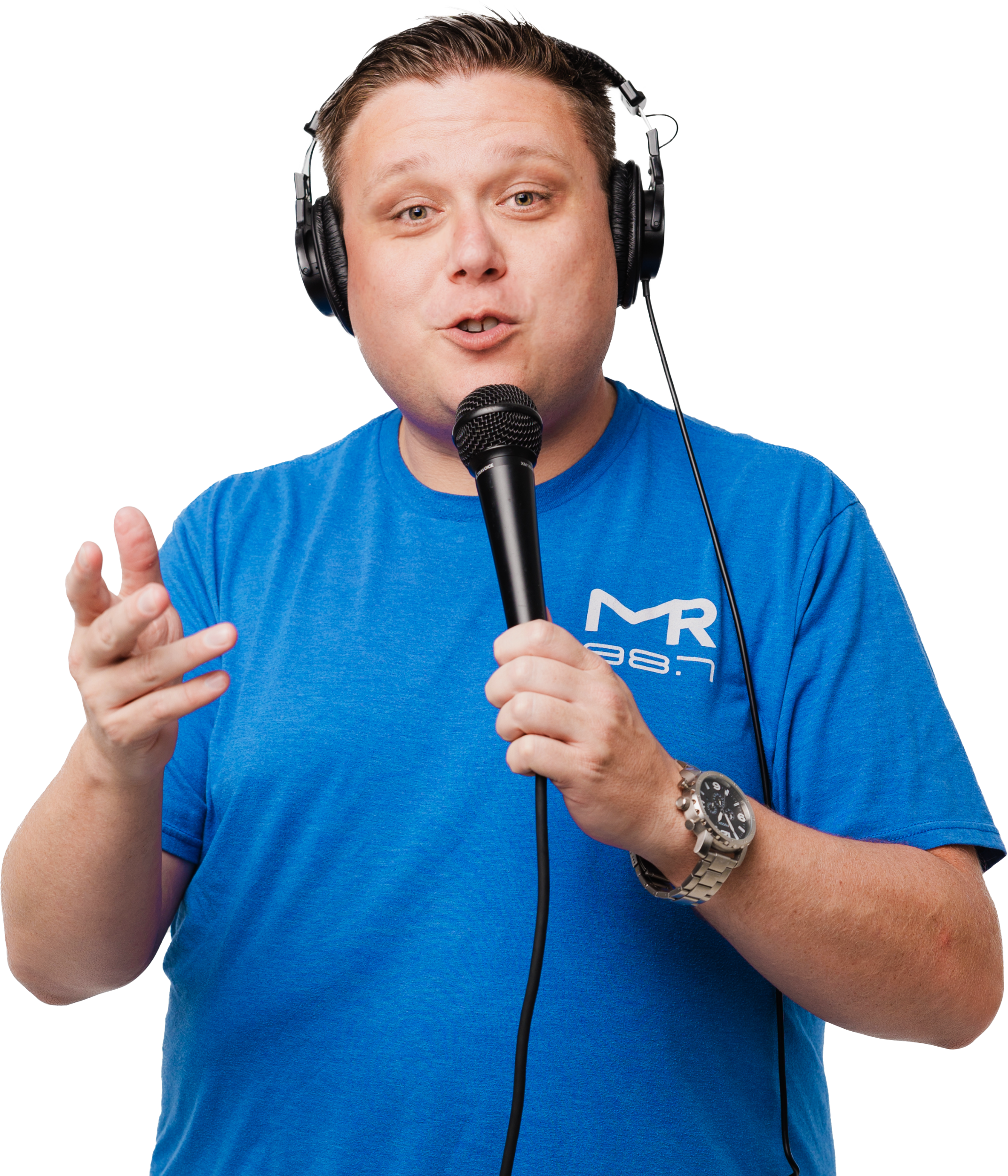Randy Slack with studio monitors on holding a microphone in a royal blue shirt